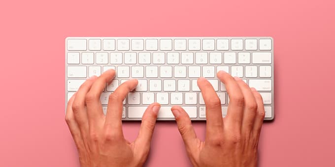 hands typing on keyboard