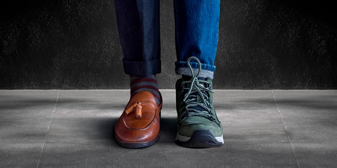 person wearing 2 different shoes